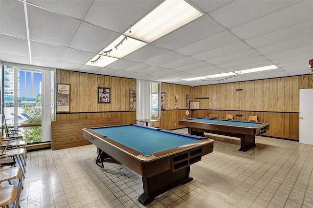 rec room featuring light floors, wood walls, billiards, and a paneled ceiling