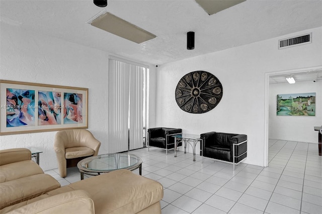 tiled living room with a textured ceiling