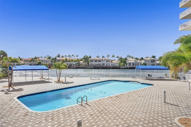 community pool featuring a patio area and a residential view