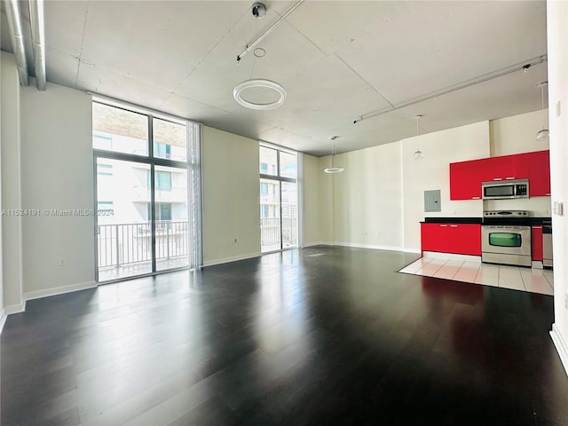 interior space with a wall of windows, hardwood / wood-style floors, and rail lighting