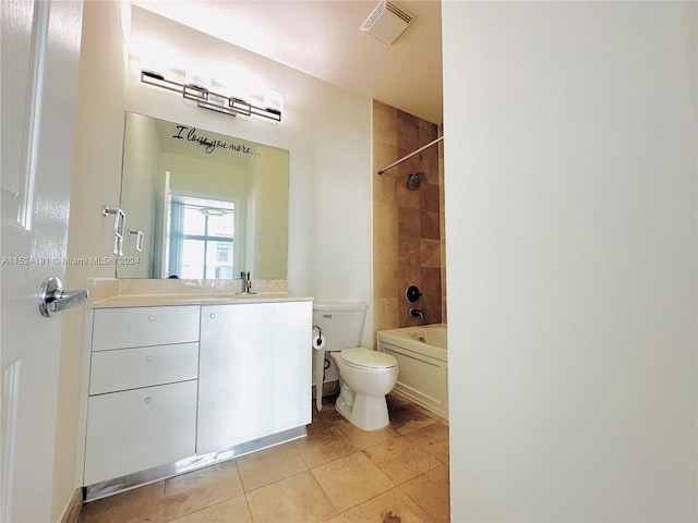 full bathroom with vanity, tile floors, toilet, and tiled shower / bath