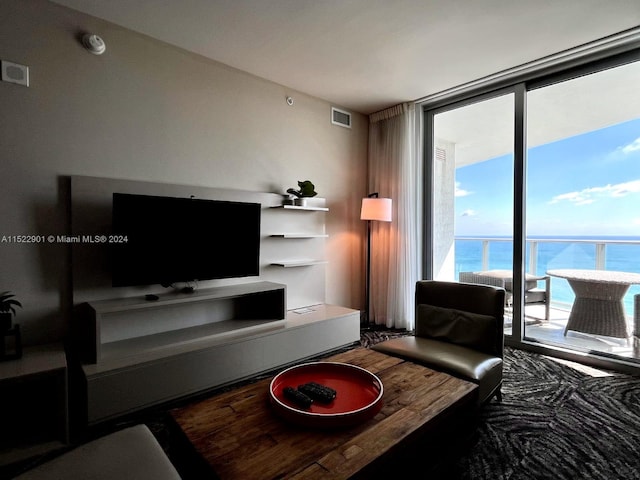 living room with a water view and floor to ceiling windows