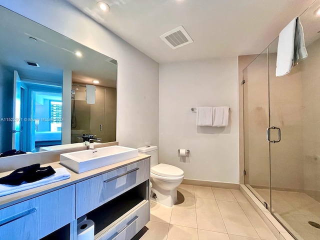 bathroom with walk in shower, tile floors, oversized vanity, and toilet