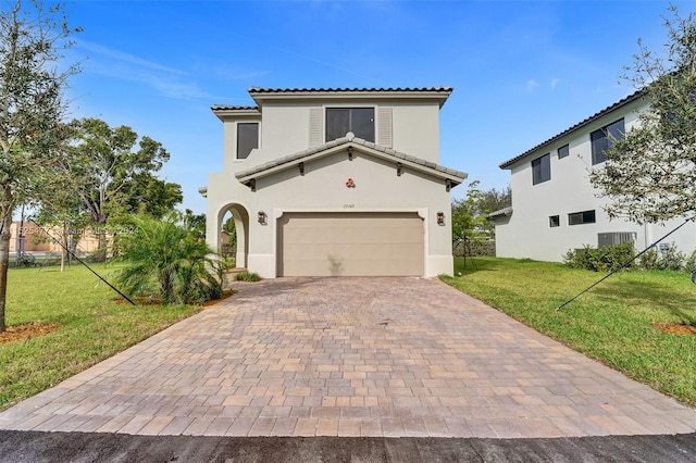 mediterranean / spanish house with a front yard and a garage