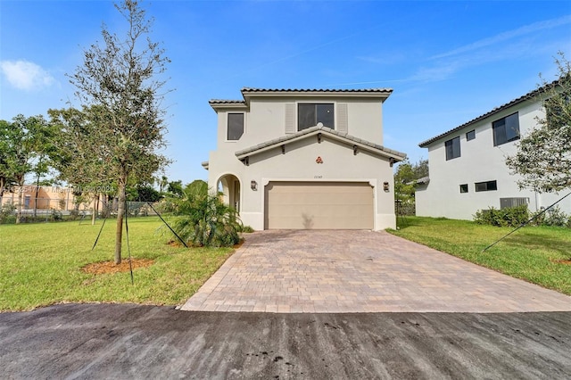 mediterranean / spanish house featuring a front lawn and a garage