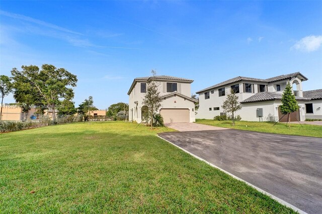 mediterranean / spanish house with a front lawn and a garage