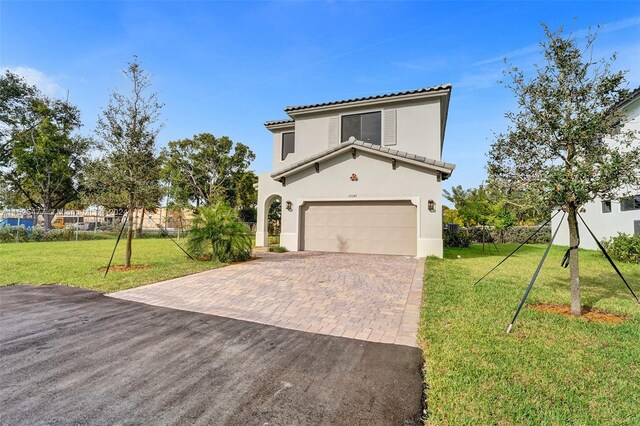 view of front facade with a front yard and a garage