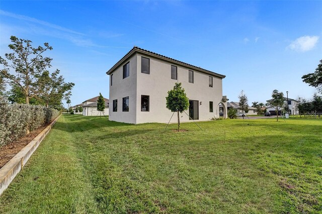 rear view of property with a yard