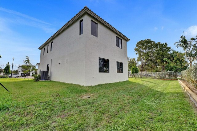 view of property exterior featuring a lawn