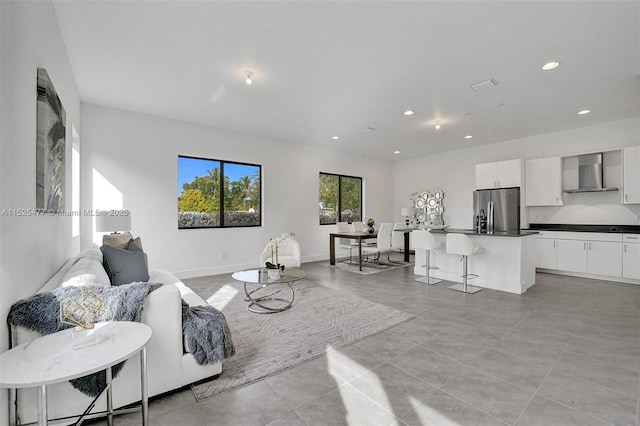 living room with baseboards and recessed lighting