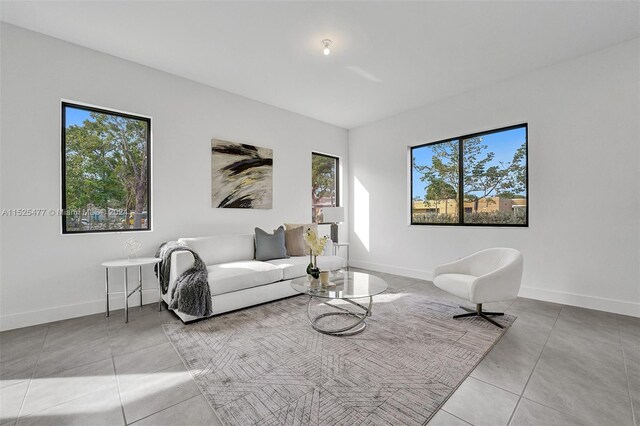 living room with plenty of natural light and light tile floors