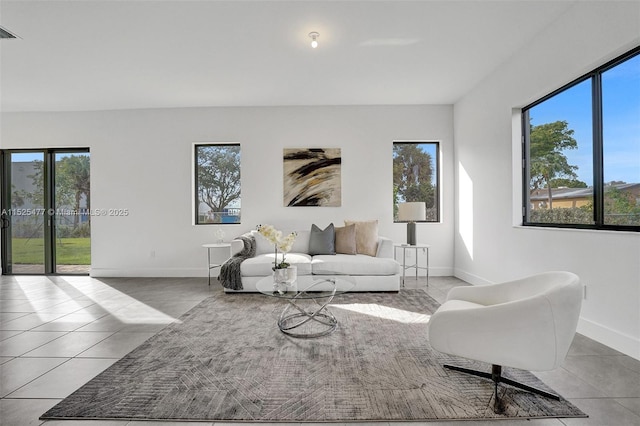 tiled living room featuring visible vents and baseboards