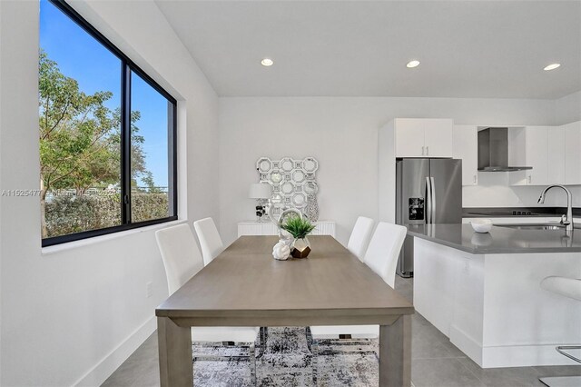 dining room featuring light tile floors and sink