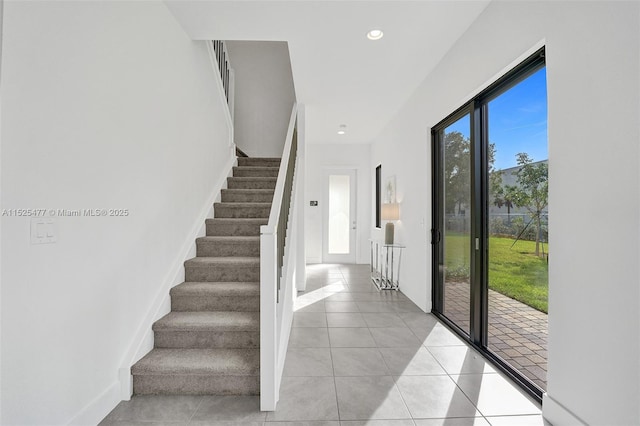 staircase with recessed lighting, tile patterned flooring, and baseboards