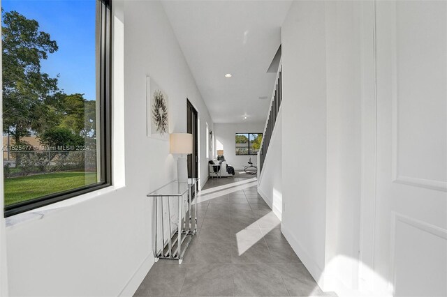 hallway featuring light tile floors and a wealth of natural light