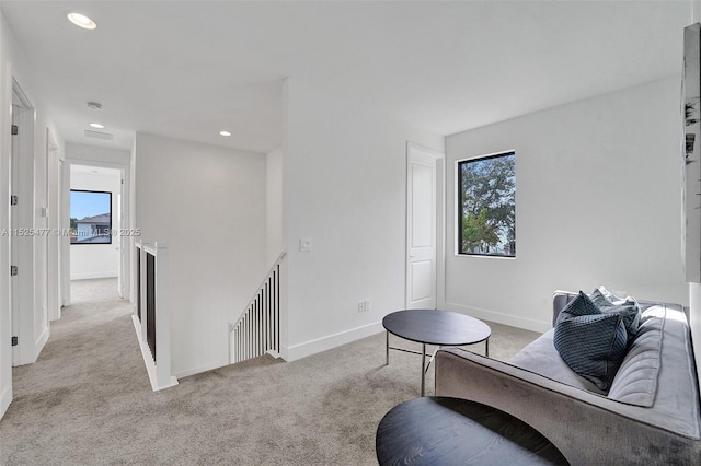 living area with baseboards, light carpet, an upstairs landing, and recessed lighting
