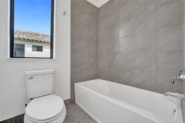 bathroom featuring toilet and tile floors