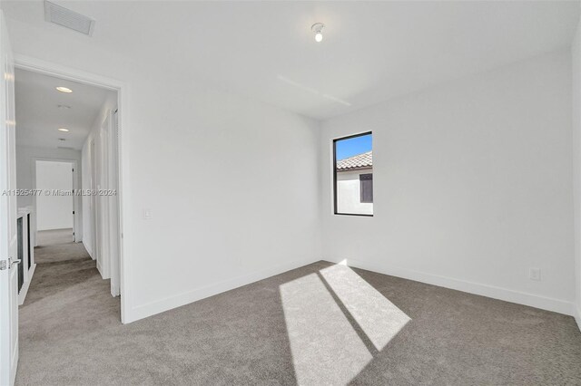 empty room with light colored carpet