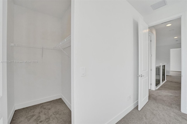 walk in closet with visible vents and carpet flooring