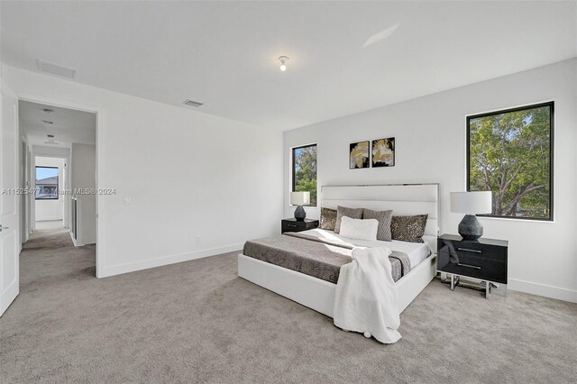 bedroom featuring light colored carpet