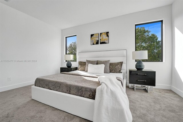 bedroom featuring light carpet