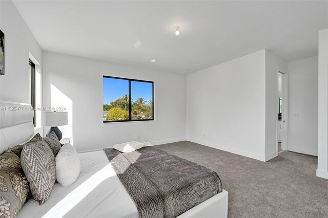 bedroom with light colored carpet