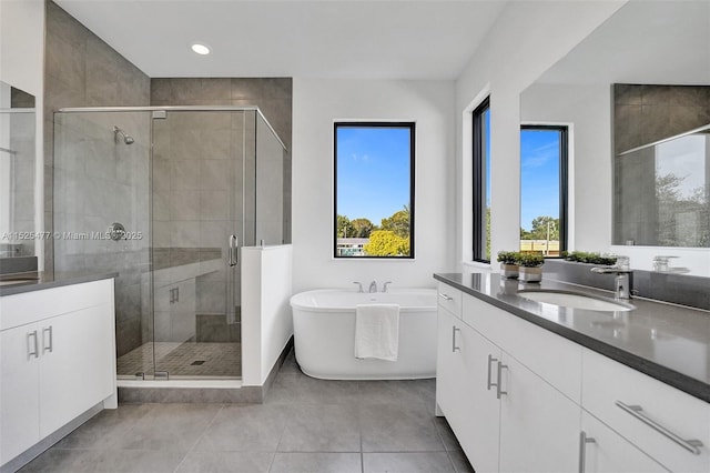 full bath featuring recessed lighting, a shower stall, tile patterned flooring, a freestanding bath, and vanity