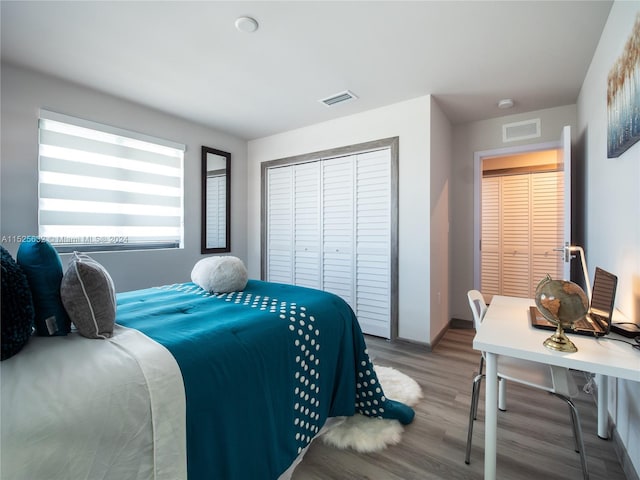 bedroom with hardwood / wood-style floors and a closet