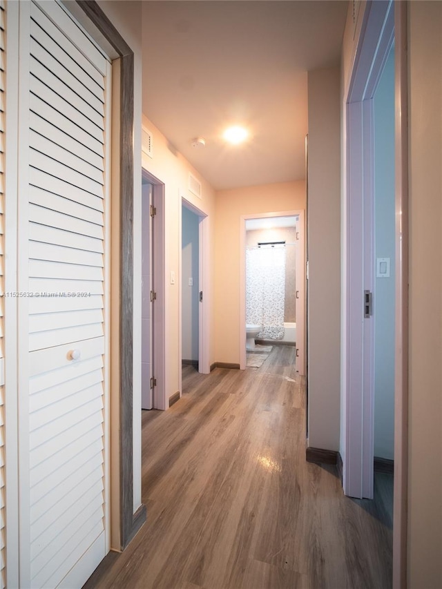 hall with dark wood-type flooring