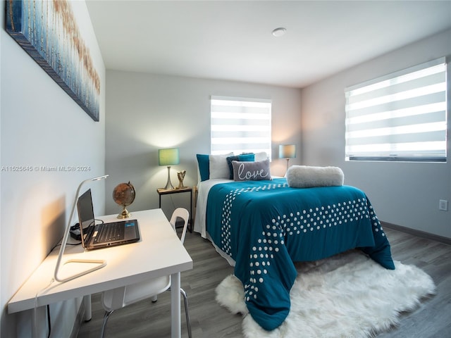 bedroom with dark hardwood / wood-style floors