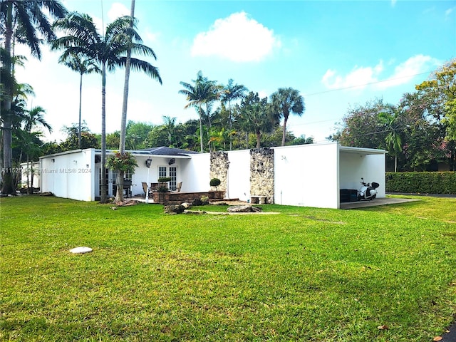 rear view of house with a yard