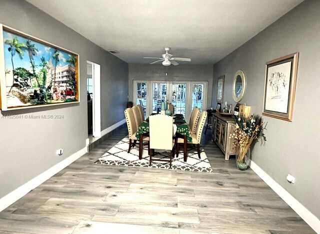 dining space featuring french doors, ceiling fan, and hardwood / wood-style flooring