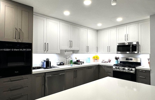 kitchen with white cabinets, sink, and stainless steel appliances