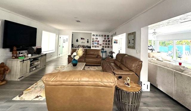 living room with ornamental molding, dark hardwood / wood-style flooring, and ceiling fan