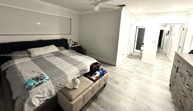 bedroom featuring ornamental molding, ceiling fan, and light hardwood / wood-style flooring