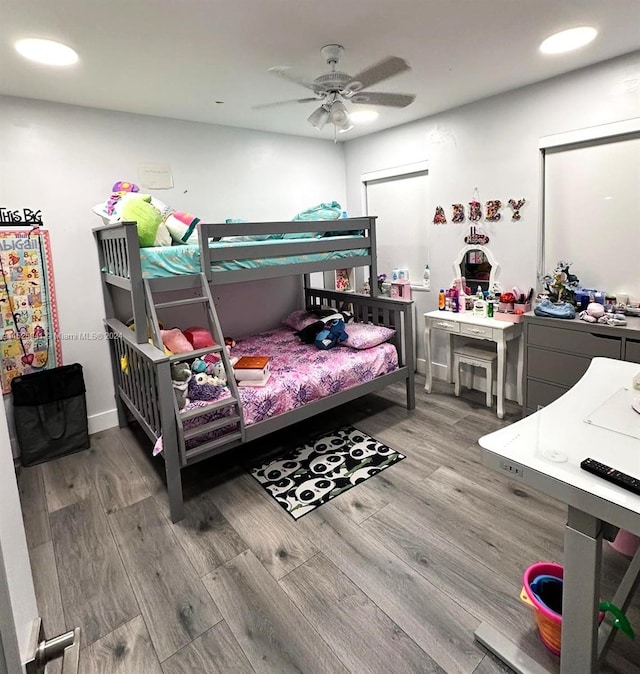 bedroom with ceiling fan and wood-type flooring