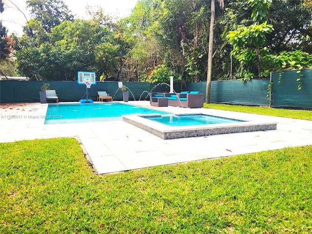 view of swimming pool with an in ground hot tub, a yard, and a patio