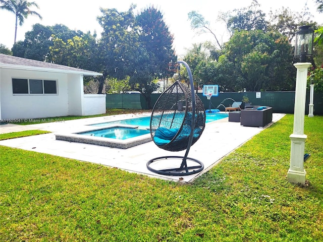 view of pool with an in ground hot tub, a yard, and a patio