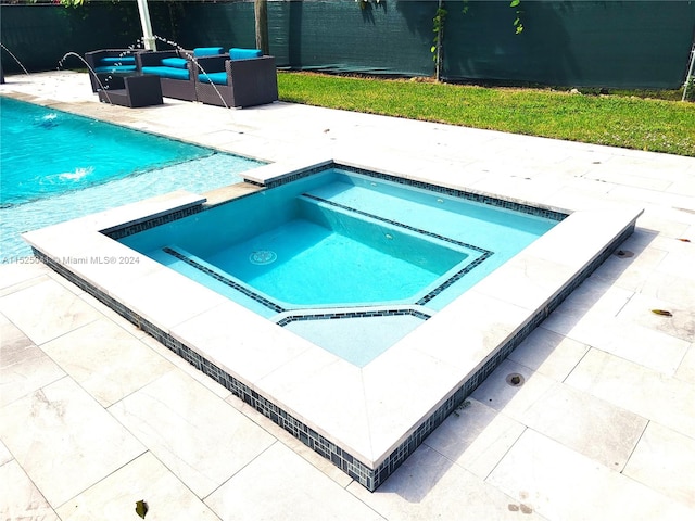 view of swimming pool with an outdoor hangout area, a patio, an in ground hot tub, and pool water feature