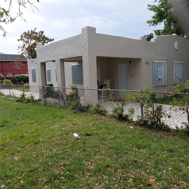 rear view of property featuring a yard