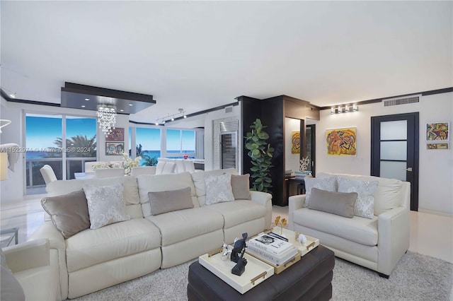 living room with track lighting and an inviting chandelier