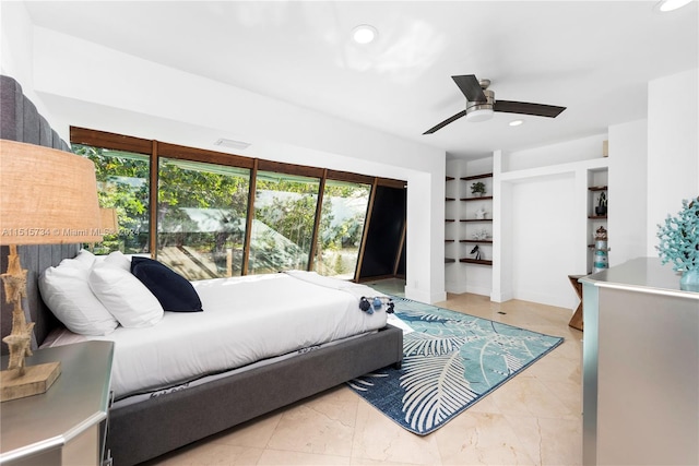 tiled bedroom with ceiling fan and multiple windows