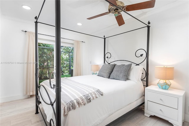 bedroom featuring ornamental molding, ceiling fan, and light wood-type flooring