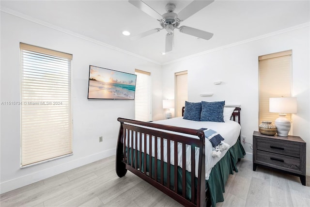 bedroom featuring crown molding, ceiling fan, and light hardwood / wood-style flooring