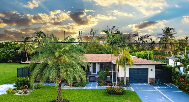 view of front of property featuring a yard and a garage