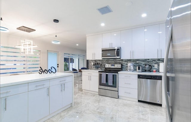 kitchen featuring hanging light fixtures, stainless steel appliances, white cabinetry, and light tile floors