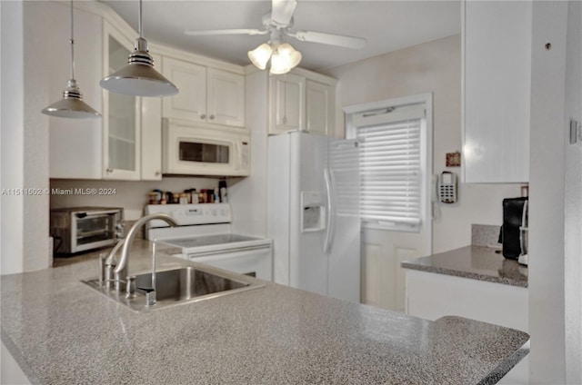 kitchen with decorative light fixtures, white appliances, ceiling fan, white cabinets, and sink