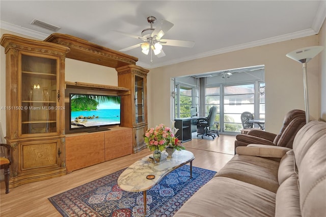 living room featuring ceiling fan, crown molding, and light wood-type flooring