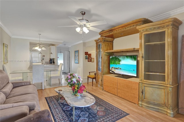 living room featuring ornamental molding, ceiling fan with notable chandelier, and light wood-type flooring