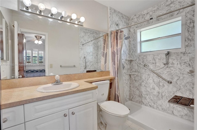 bathroom with tile flooring, ceiling fan, walk in shower, toilet, and vanity